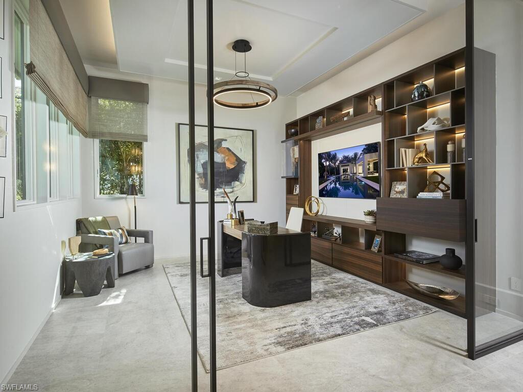 477 3rd Street North Naples, FL 34102 - Photo 18 of 33 a living room with furniture and a flat screen tv