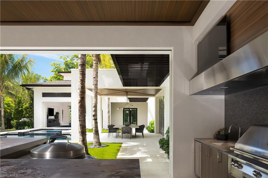 477 3rd Street North Naples, FL 34102 - Photo 27 of 33 a view of swimming pool with outdoor seating