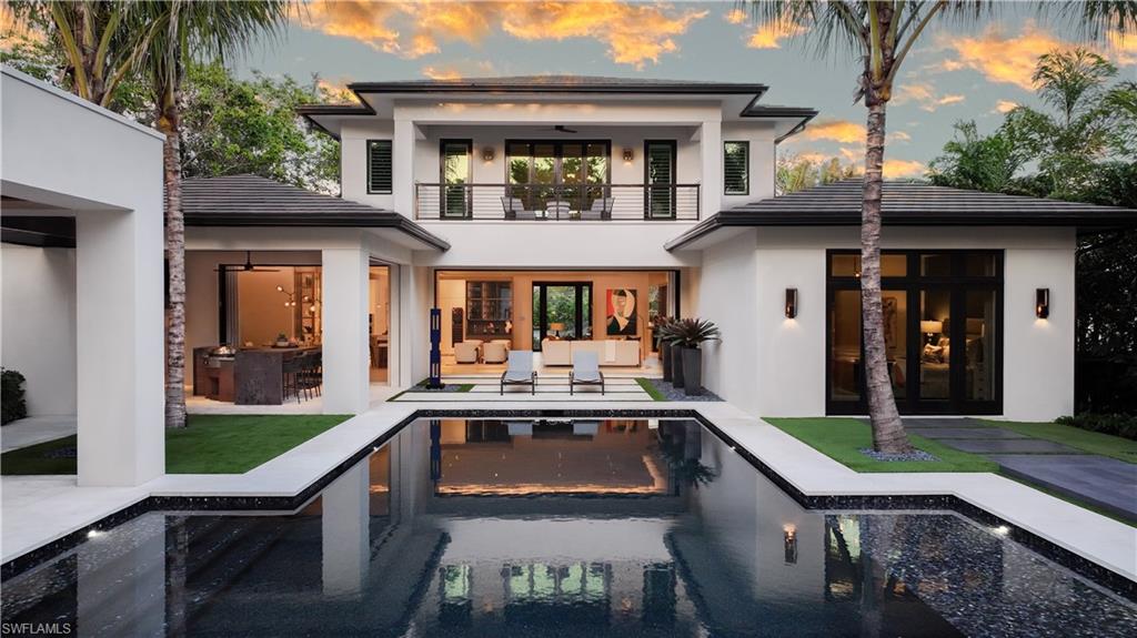 477 3rd Street North Naples, FL 34102 - Photo 3 of 33 a front view of house with yard outdoor seating and green space