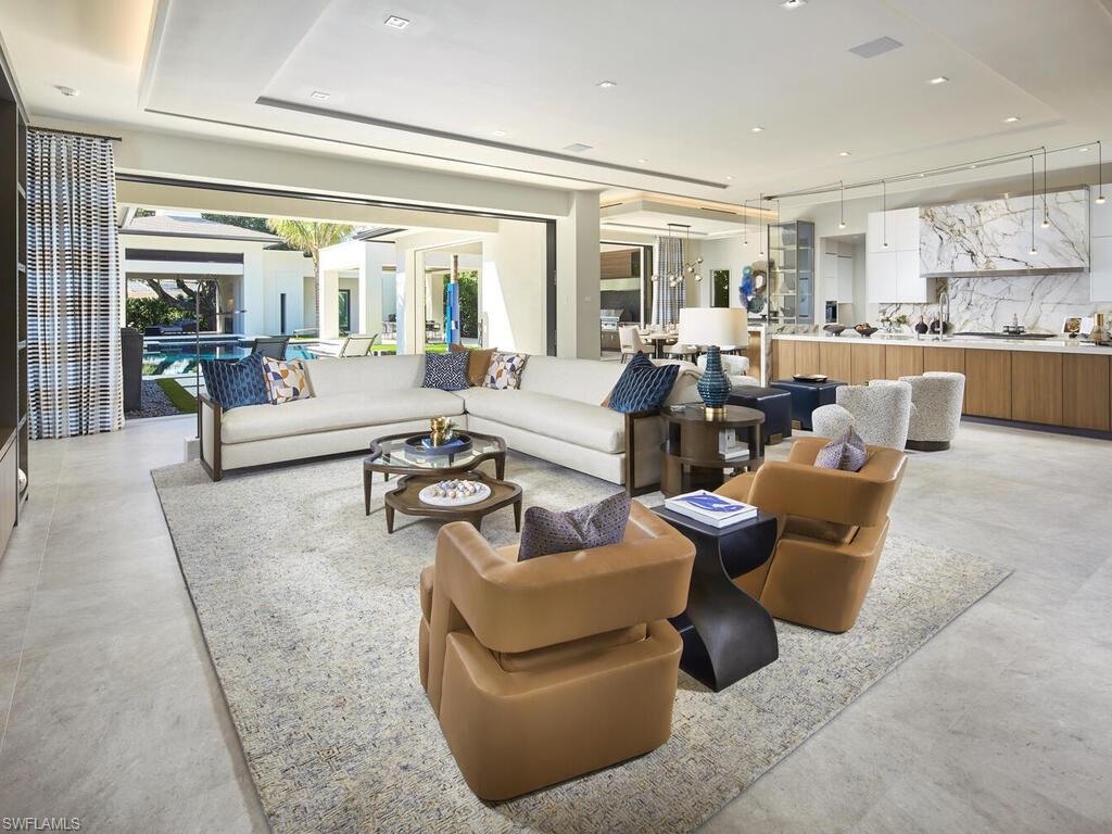 477 3rd Street North Naples, FL 34102 - Photo 5 of 33 a living room with furniture and a large window