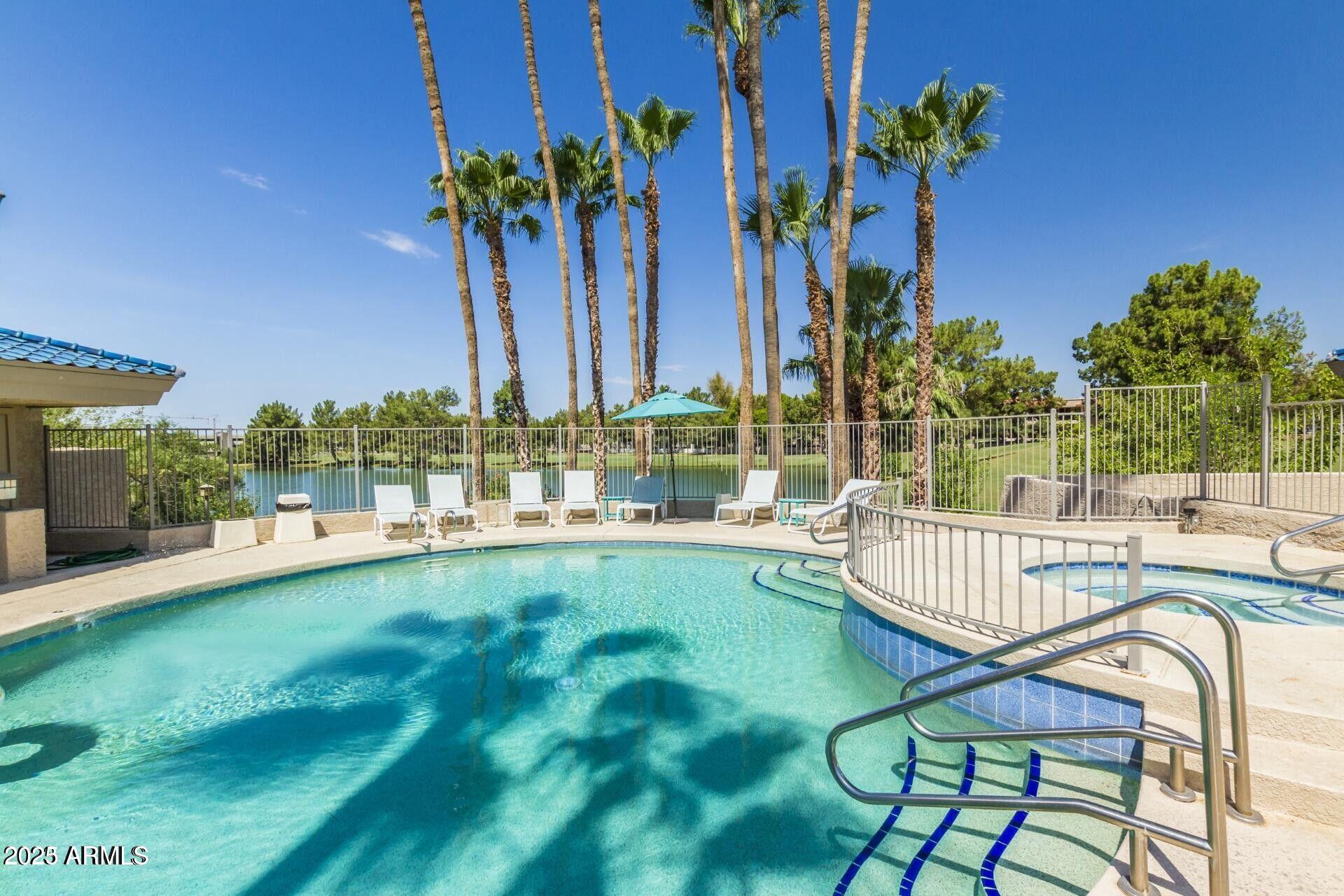 5122 North 31st Way, Unit 238 Phoenix, AZ 85016 - Photo 15 of 21 a view of a swimming pool with a patio and a yard