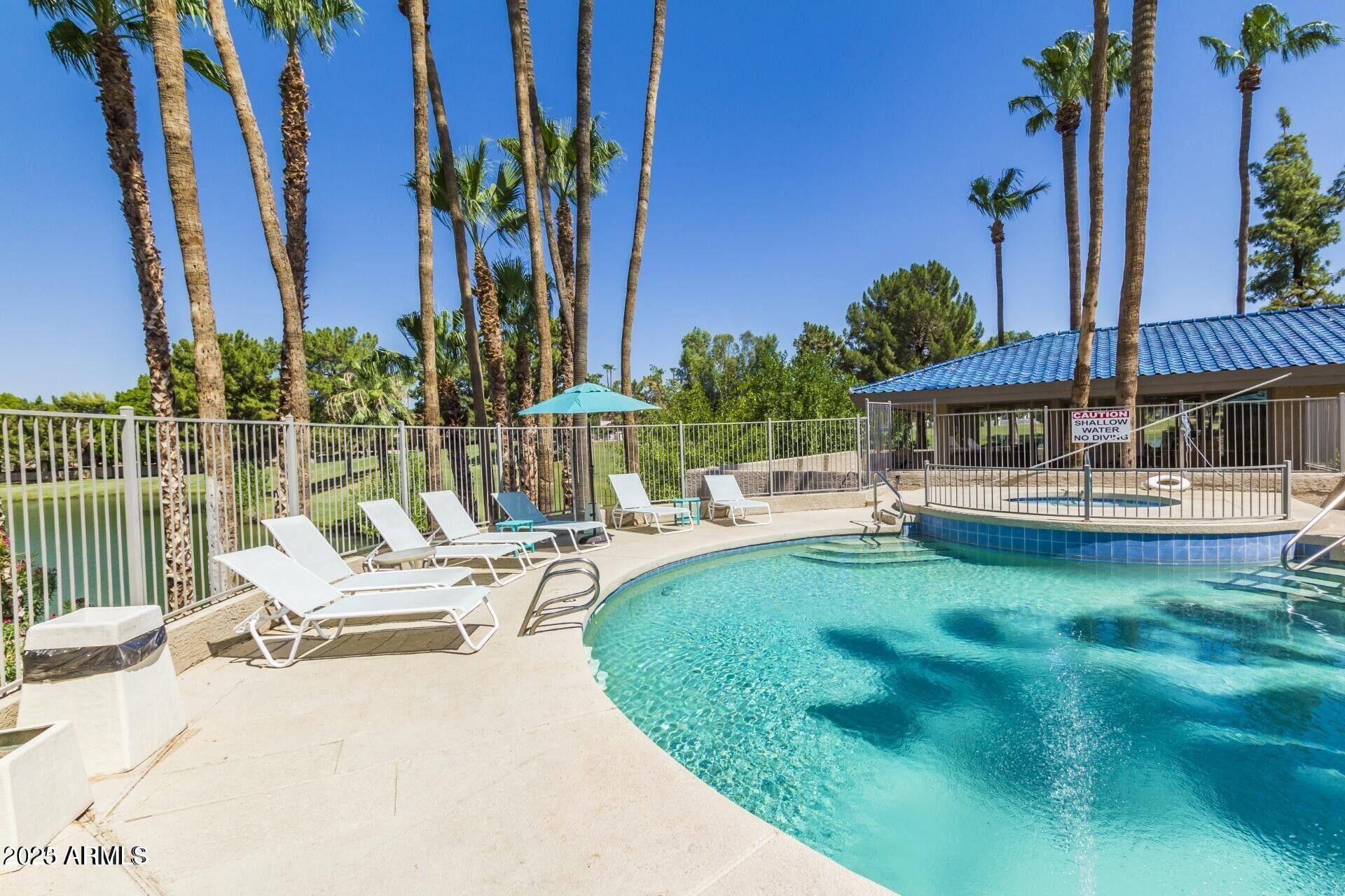5122 North 31st Way, Unit 238 Phoenix, AZ 85016 - Photo 16 of 21 a view of swimming pool with chairs and table in patio