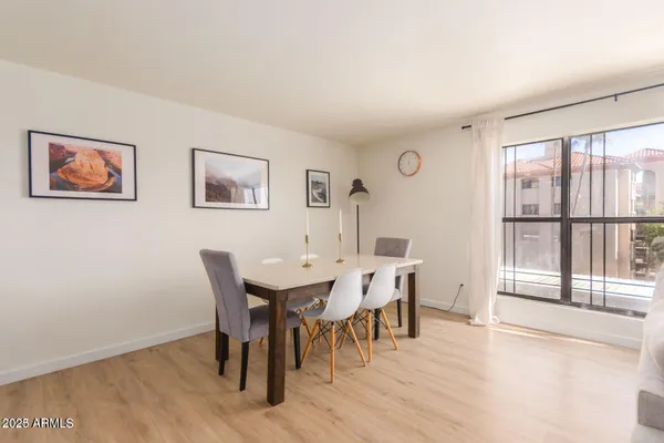 a view of a dining room with furniture and wooden floor