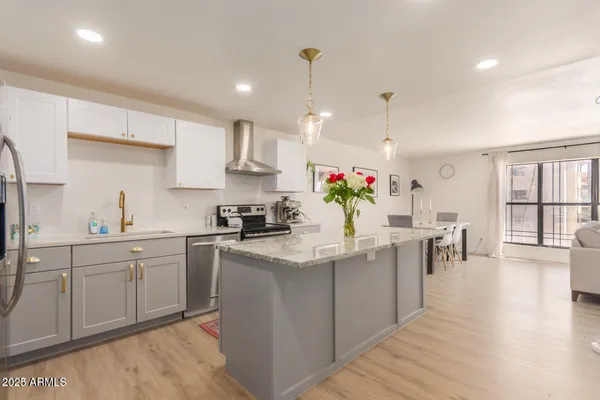 a kitchen that has a lot of cabinets a sink in it and wooden floors