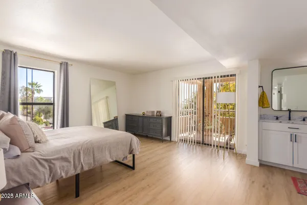 a bedroom with a bed and a large window