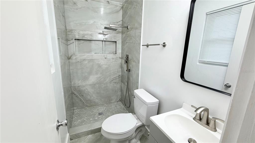 6310 Lake Underhill Road, Unit A Orlando, FL 32807 - Photo 12 of 12 a white toilet sitting next to a bathroom sink