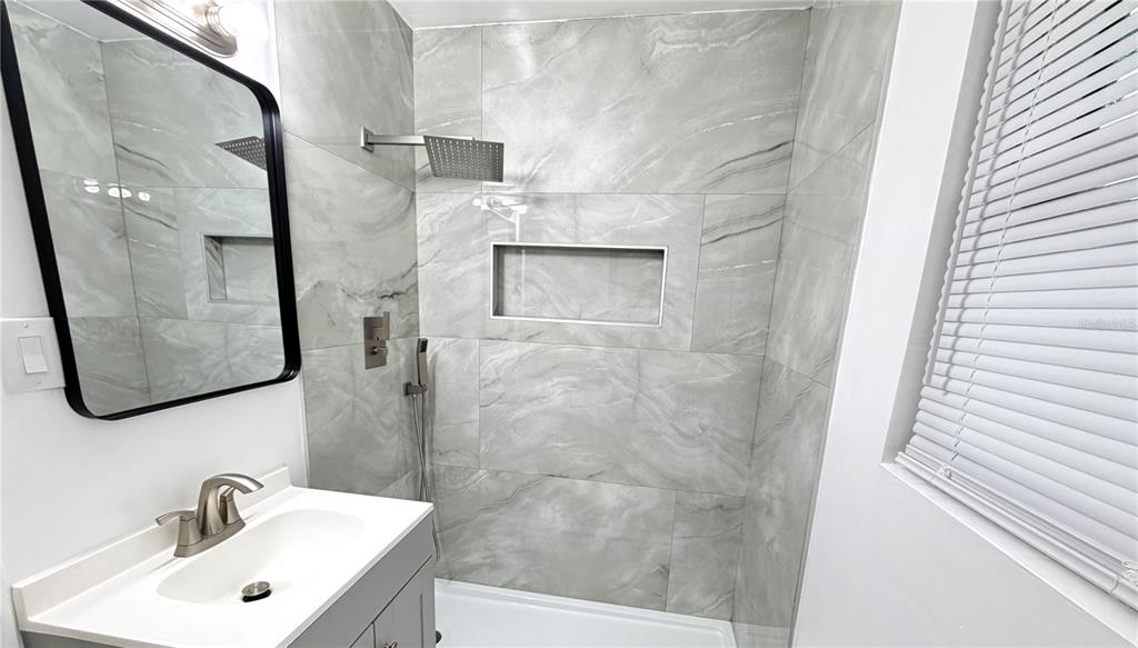 6310 Lake Underhill Road, Unit A Orlando, FL 32807 - Photo 9 of 12 a bathroom with a sink and mirror