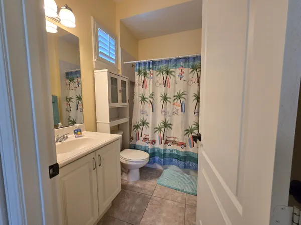 a bathroom with a sink toilet a mirror and shower