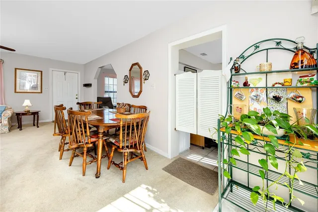 a view of a dining room with furniture and chandelier