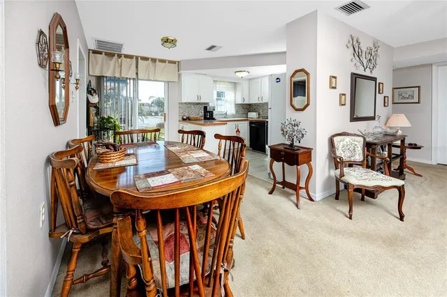 a view of a dining room with furniture and a large window