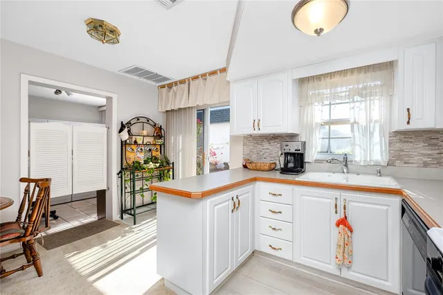 a kitchen that has a lot of cabinets in it and appliances