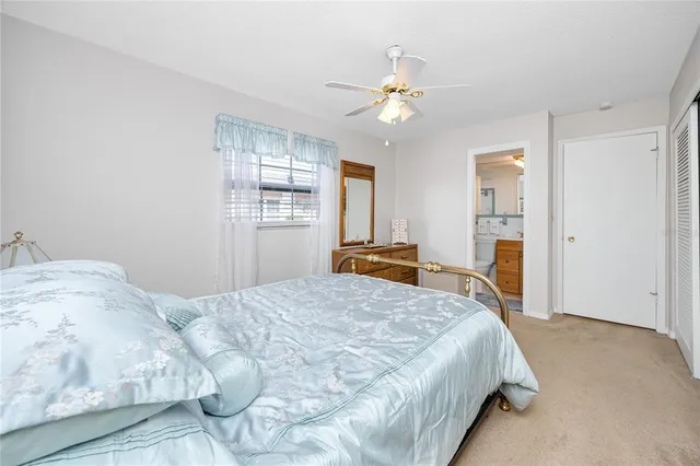 a bedroom with a bed and dresser with mirror