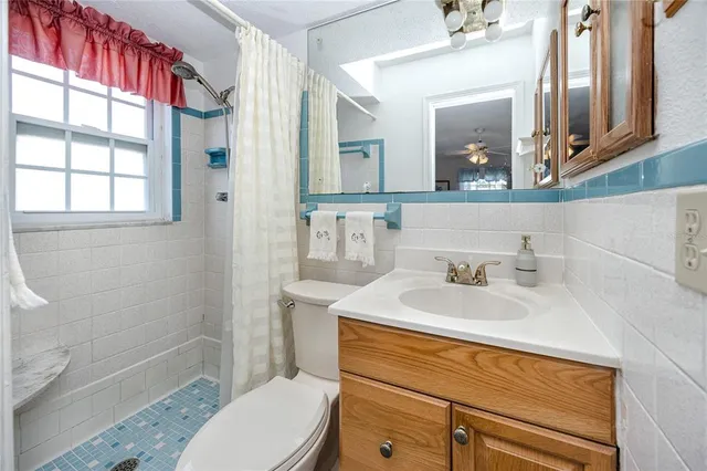 a bathroom with a sink toilet vanity and shower