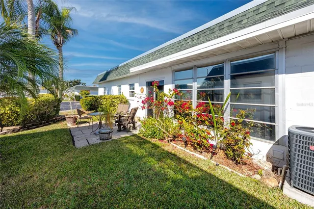 a front view of a house with outdoor seating
