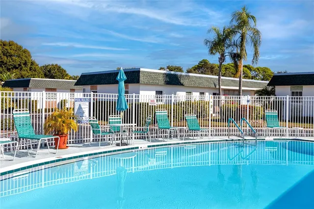 a view of a swimming pool with outdoor seating