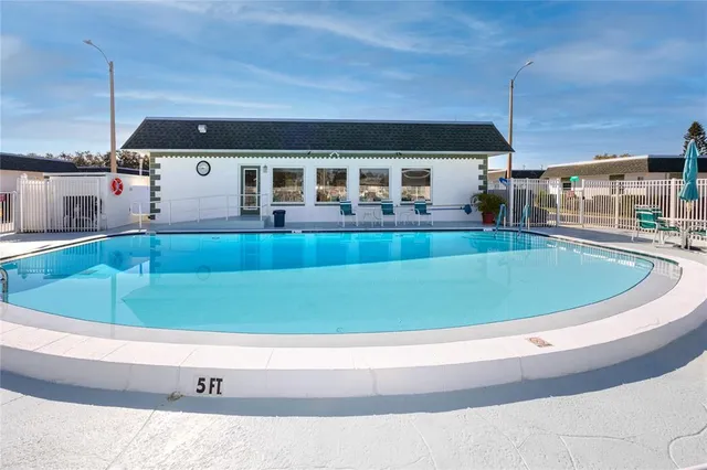 a view of swimming pool with seating space