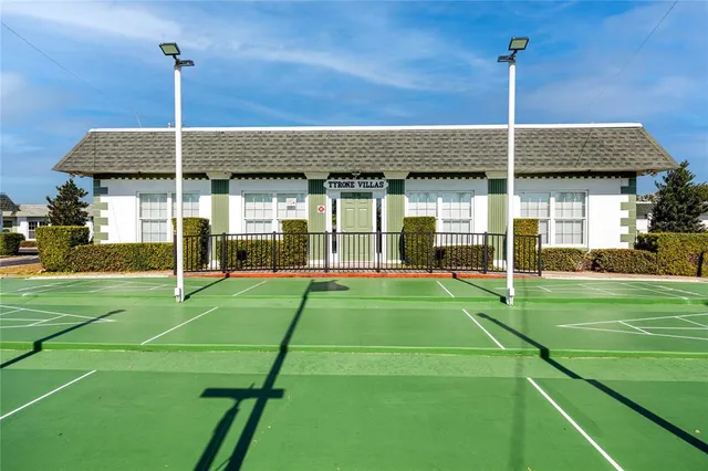 a backyard of a house with table and chairs