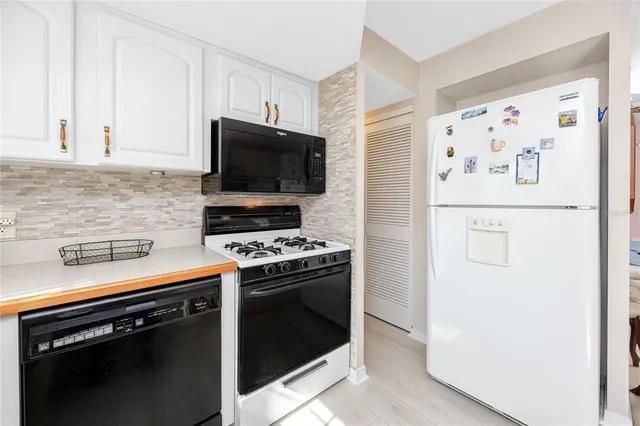 a kitchen with granite countertop a stove and a refrigerator