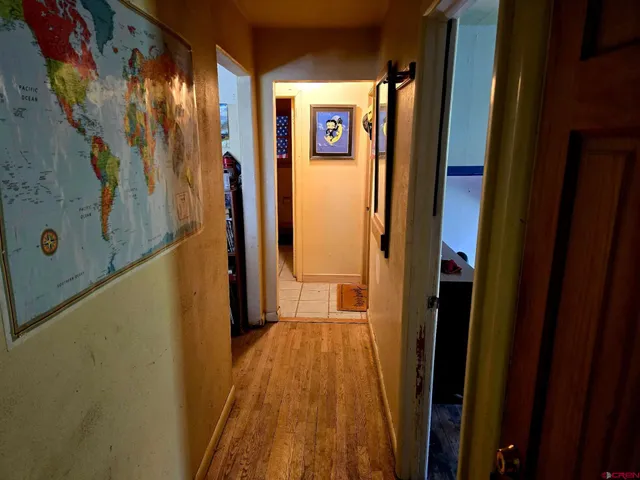 a kitchen with wooden floors and white appliances