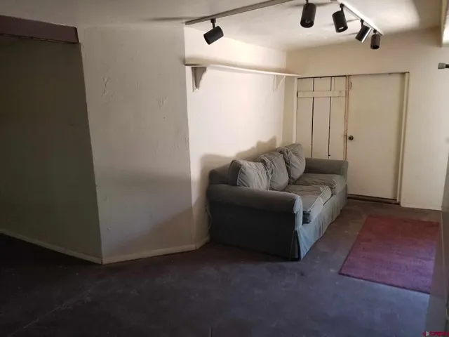 a bedroom with a bed and a television