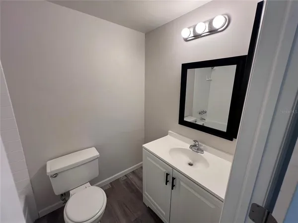 a view of a room with wooden floor and window