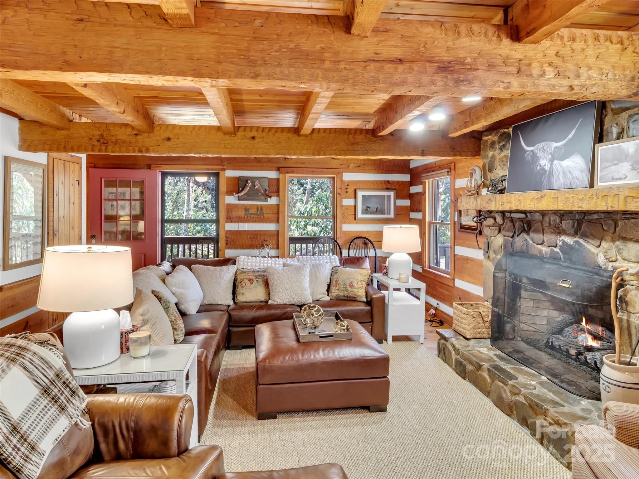 7810 Little Snowbird Road Robbinsville, NC 28771 - Photo 11 of 48 a living room with furniture and a fireplace