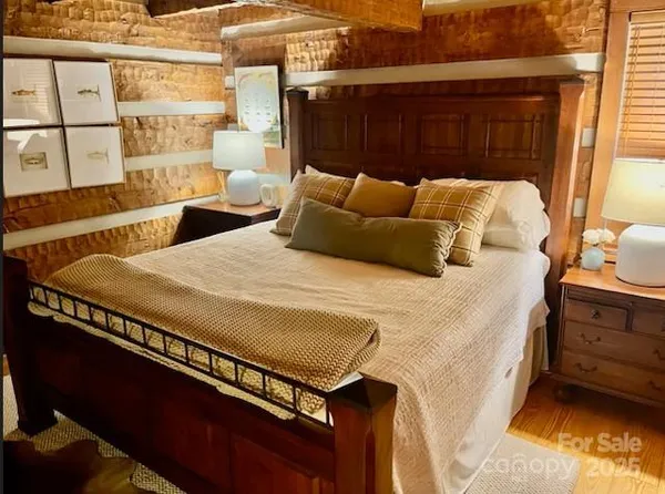 a bed sitting in a bedroom next to a window