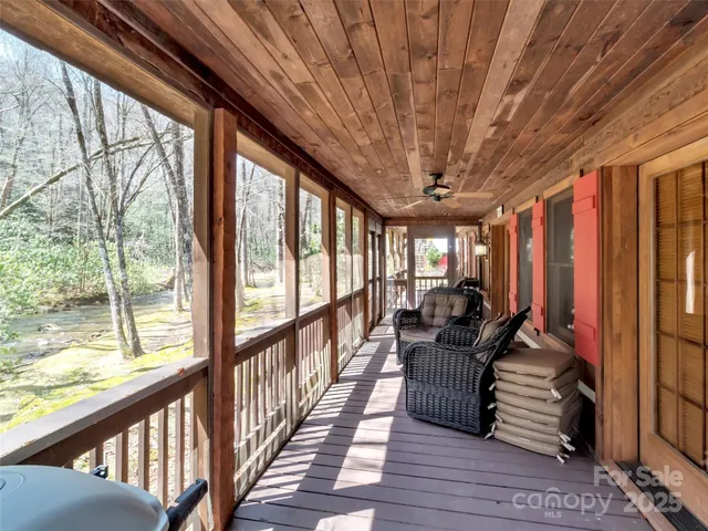 a view of a porch with chairs next to a yard