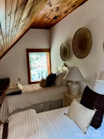 7810 Little Snowbird Road Robbinsville, NC 28771 - Photo 37 of 48 a bedroom with a large bed and a window