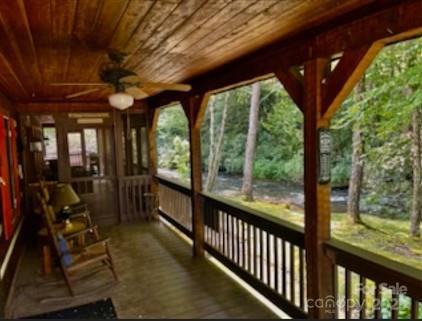 7810 Little Snowbird Road Robbinsville, NC 28771 - Photo 39 of 48 a view of a porch with chairs next to a yard