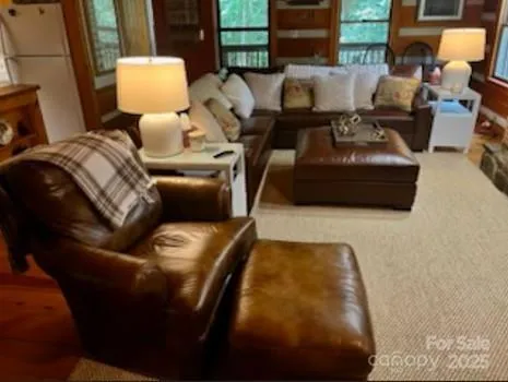 a dining room with furniture floor to ceiling windows and potted plants