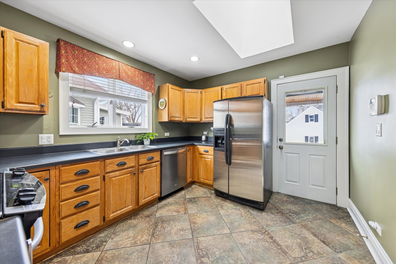 175 Berteau Avenue Elmhurst, IL 60126 - Photo 11 of 28 a kitchen with stainless steel appliances granite countertop a refrigerator and a sink