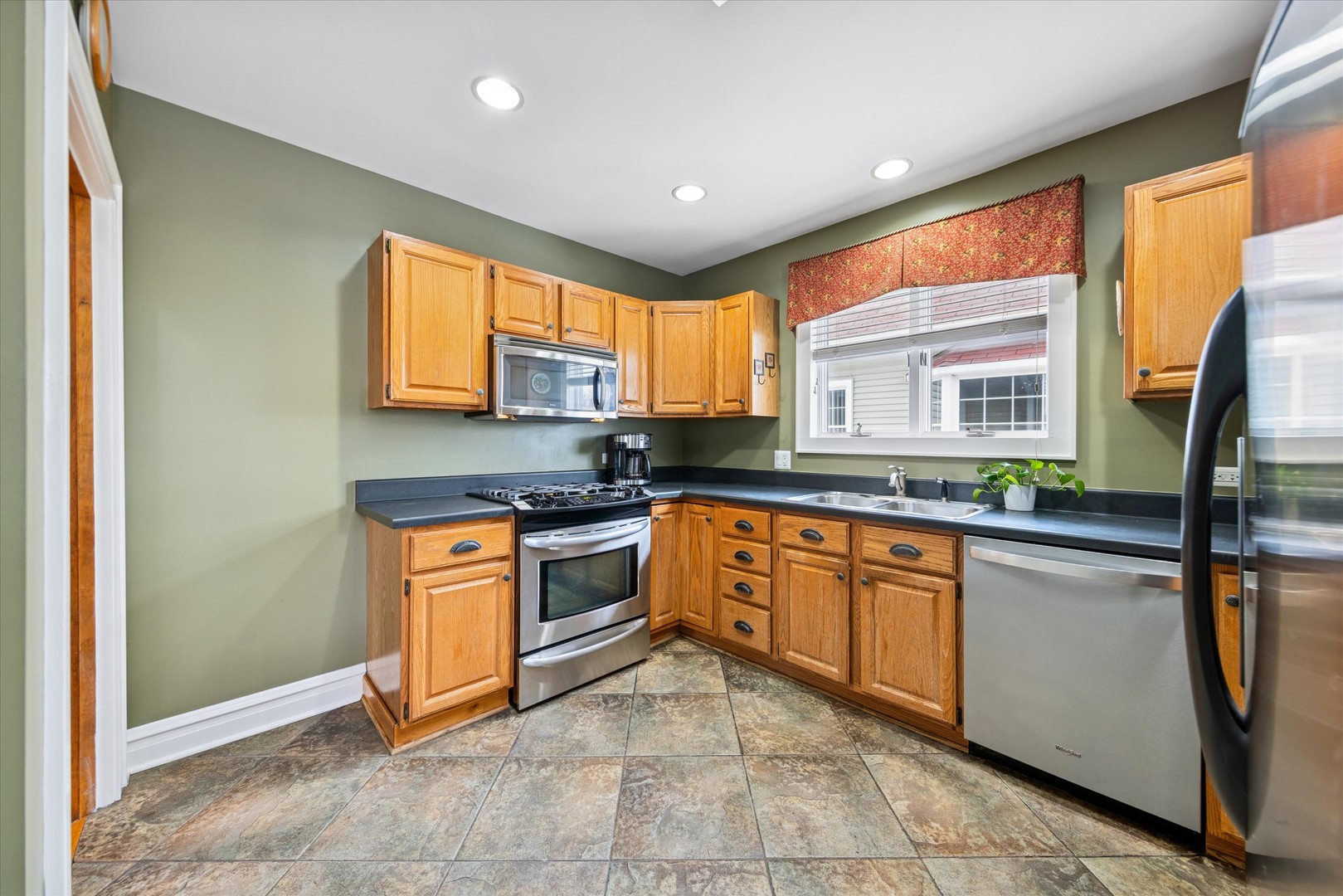 175 Berteau Avenue Elmhurst, IL 60126 - Photo 12 of 28 a kitchen with stainless steel appliances granite countertop a stove sink and cabinets