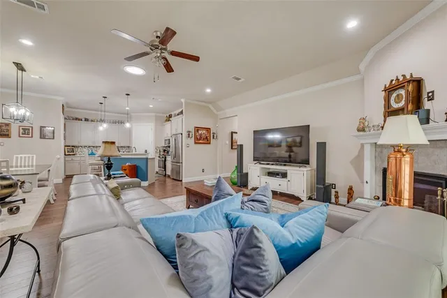 a living room with furniture kitchen view and a flat screen tv