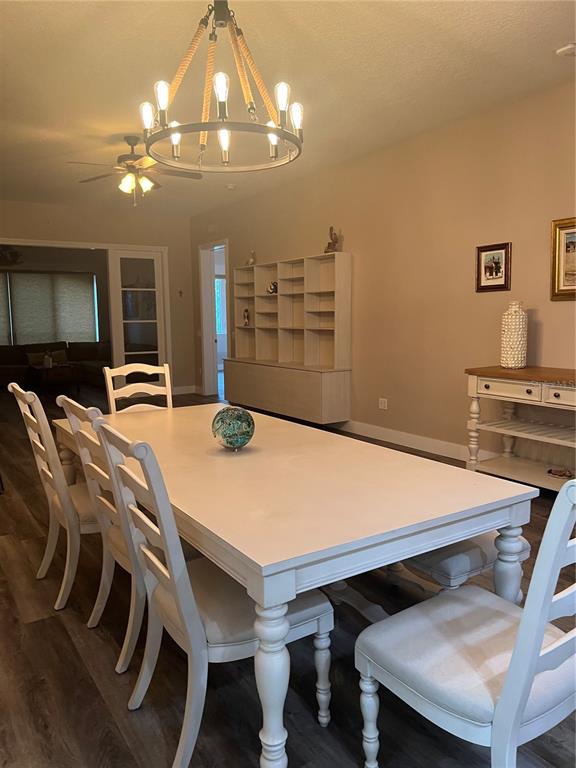 37 Harbour Isle Drive East, Unit 206 Fort Pierce, FL 34949 - Photo 12 of 37 a room with a table chairs and chandelier