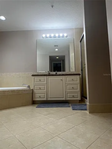 a bathroom with a bathtub a sink and a mirror