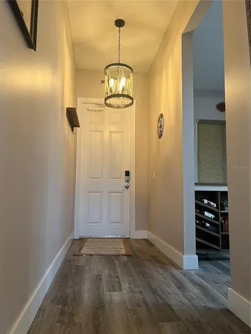 an empty room with wooden floor and cabinets