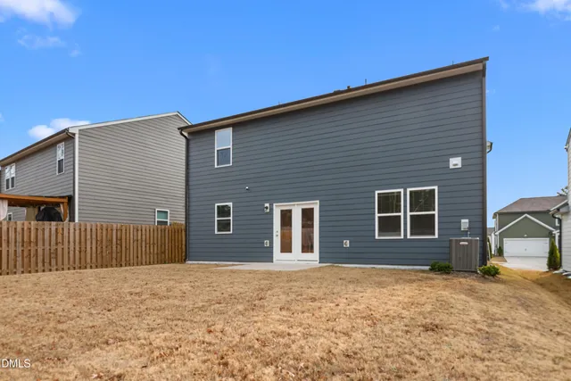 an aerial view of a house with a garden and lake view