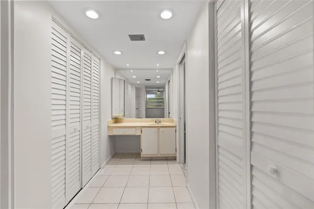 an empty room with a window and ceiling fan