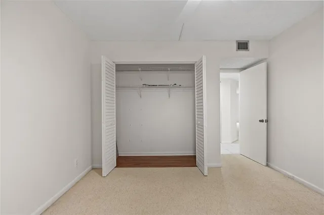 a bathroom with a toilet a sink a mirror a bathtub and vanity