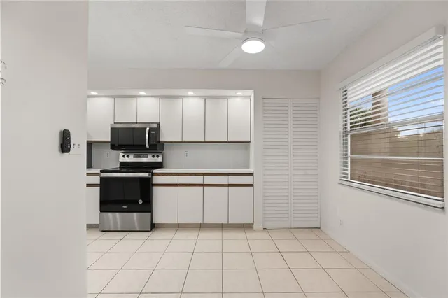 a kitchen with a stove top oven and cabinets