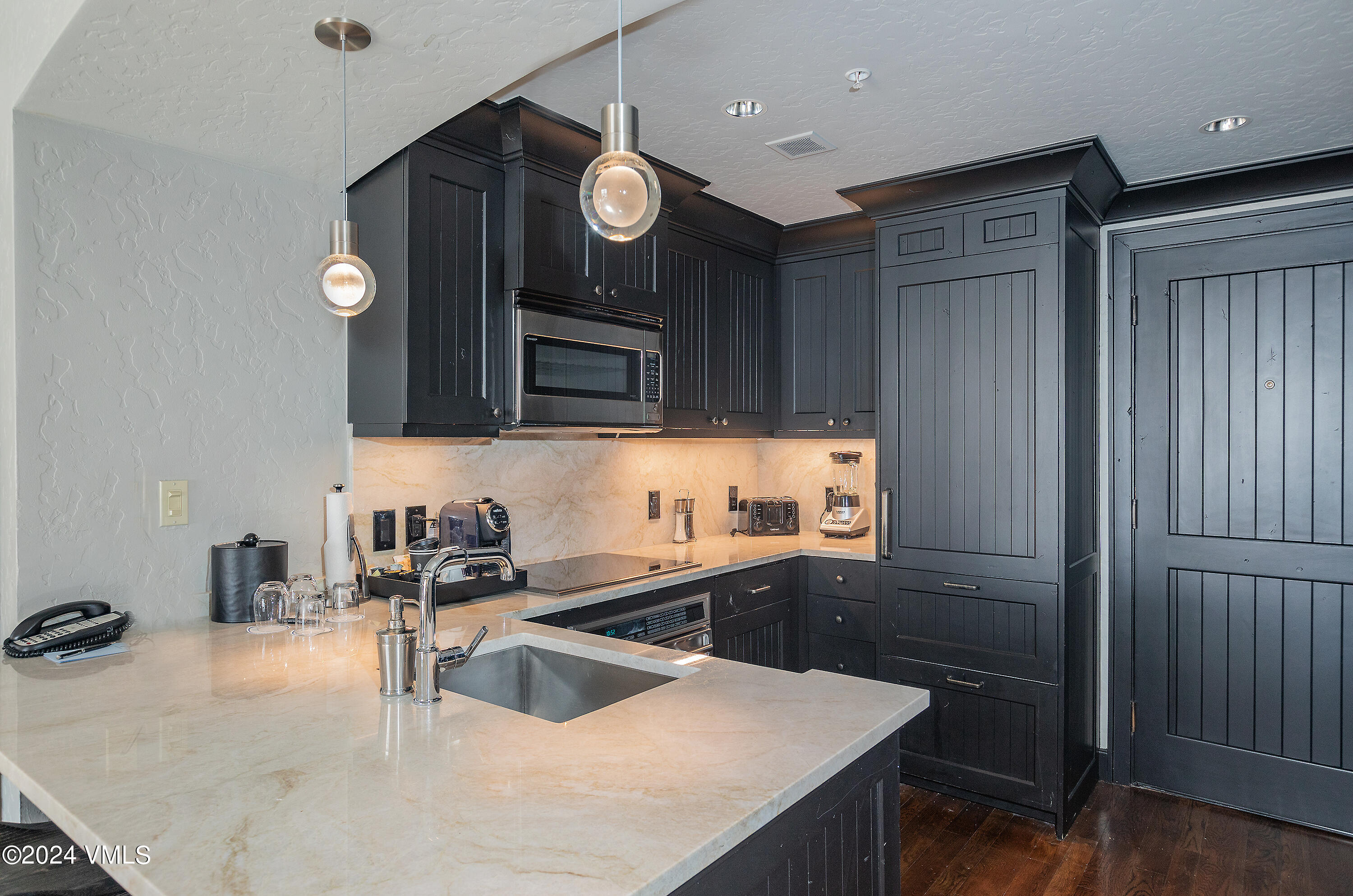 130 Daybreak Ridge Road, Unit HS658/660 Avon, CO 81620 - Photo 12 of 27 a kitchen with a sink cabinets and wooden floor