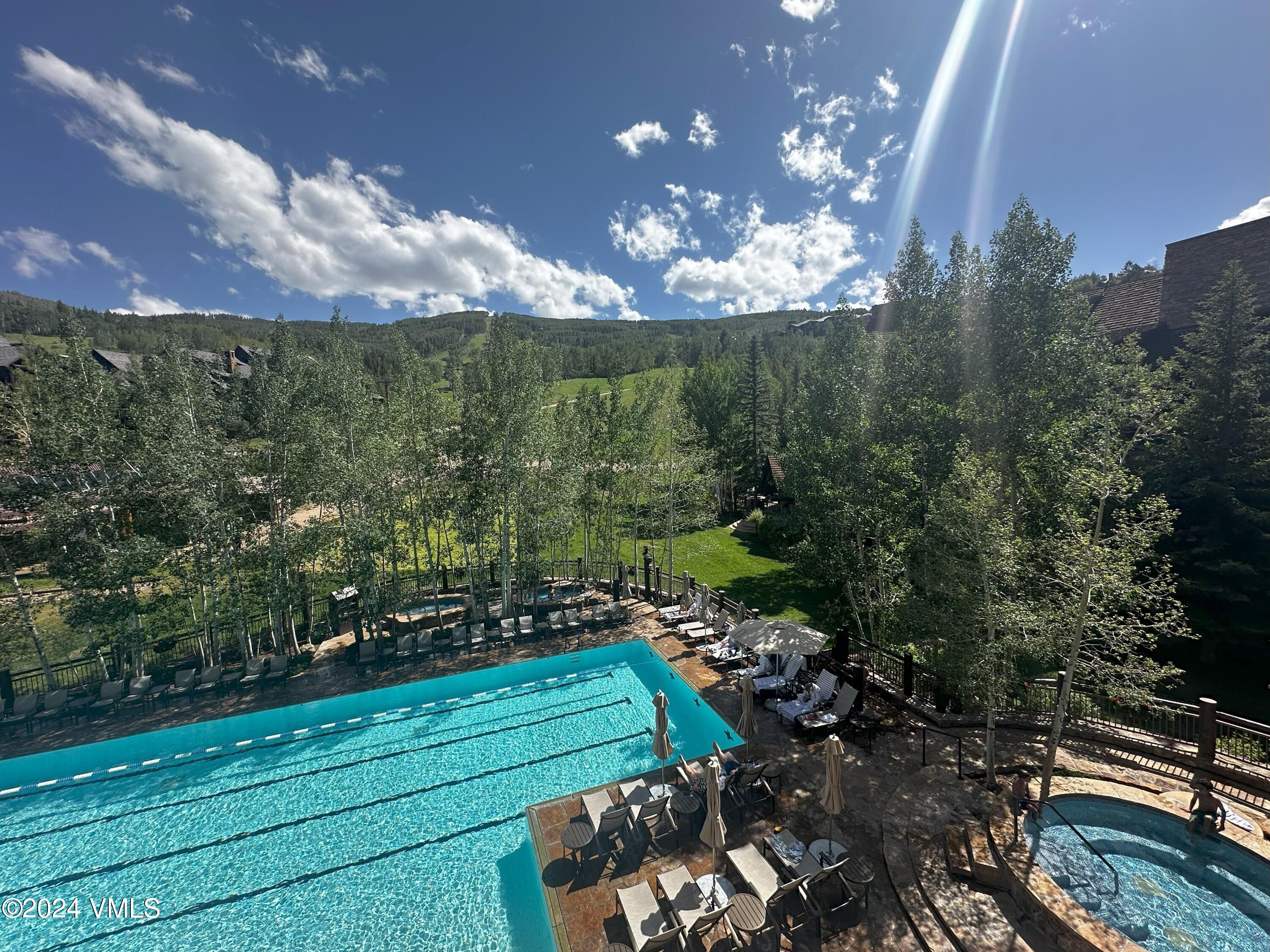 130 Daybreak Ridge Road, Unit HS658/660 Avon, CO 81620 - Photo 3 of 27 a view of a yard with lots of green space and a lake view