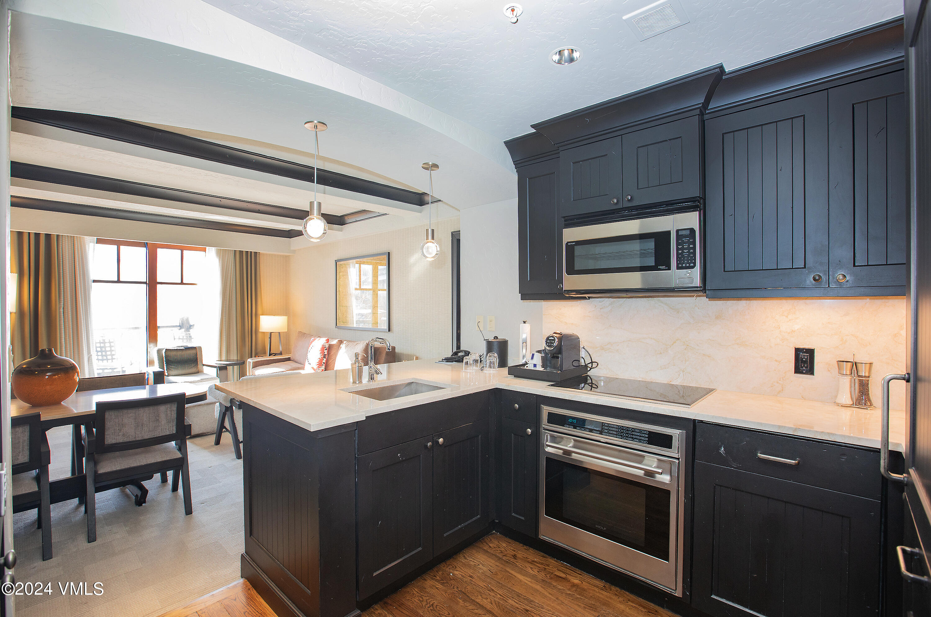 130 Daybreak Ridge Road, Unit HS658/660 Avon, CO 81620 - Photo 6 of 27 a kitchen with a sink stove and microwave