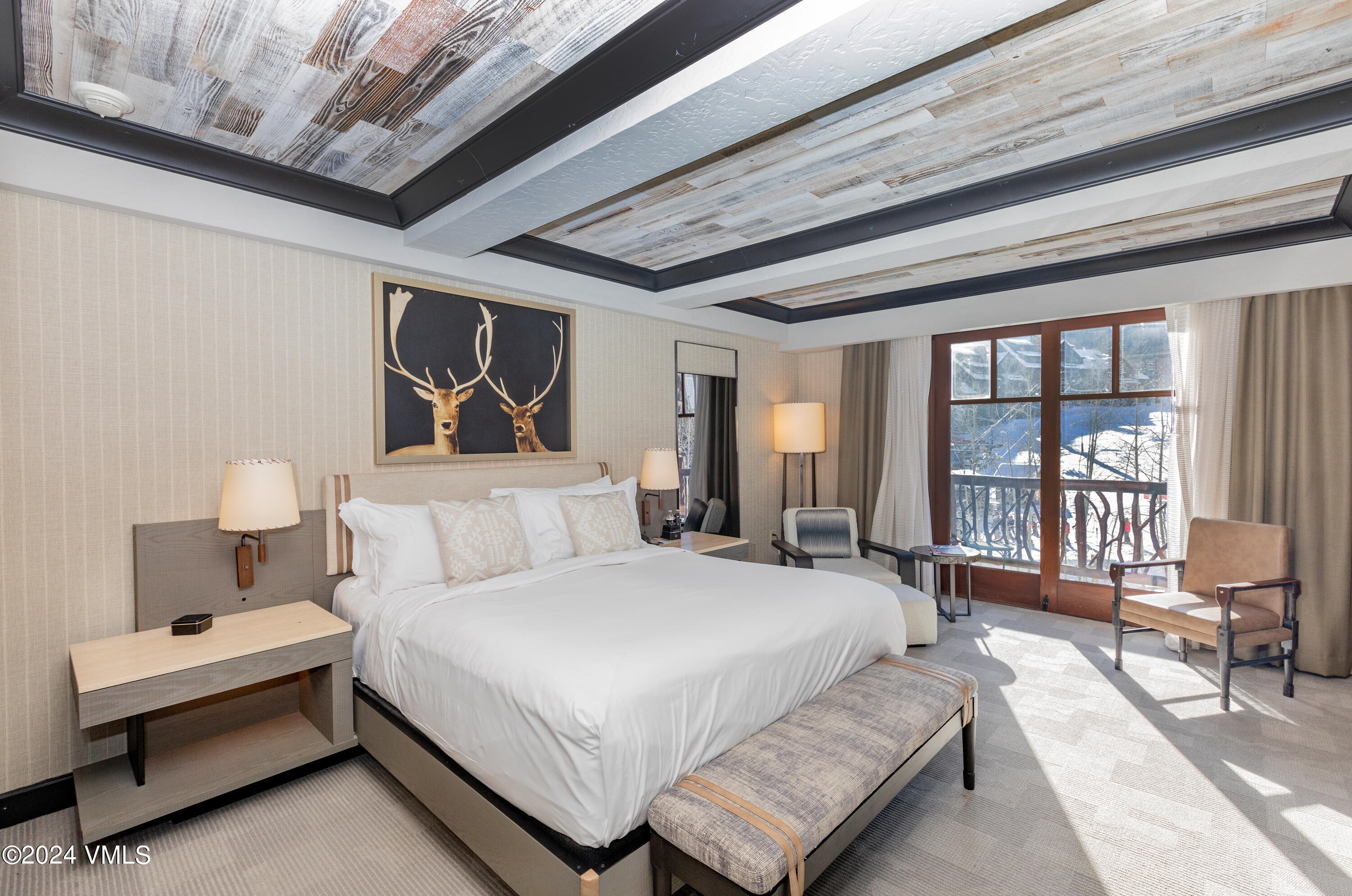 130 Daybreak Ridge Road, Unit HS658/660 Avon, CO 81620 - Photo 8 of 27 a spacious bedroom with a bed a table and large window