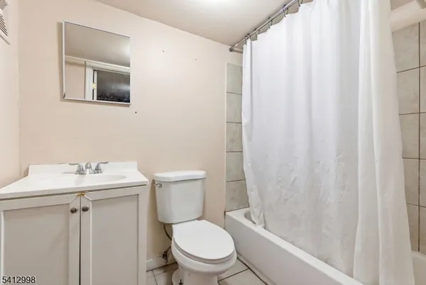 a white toilet sitting next to a bathroom sink