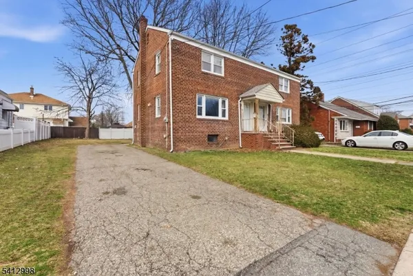a front view of a house with a yard covered with snow