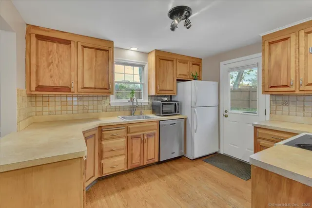 a kitchen with refrigerator and cabinets