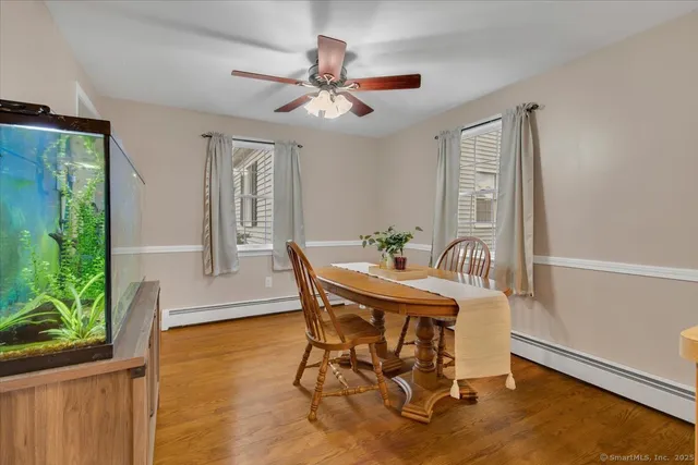 a view of a dining room with furniture and a window