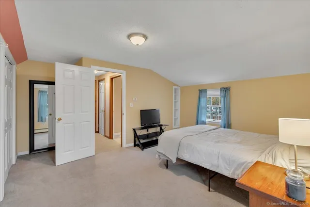 a bedroom with a bed and a couch